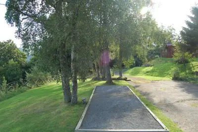 a skateboard ramp in a park with trees at Luxury woodland Alder Lodge in Killin