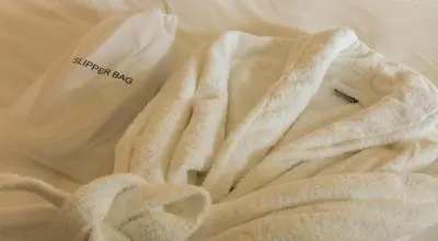a white towel sitting on top of a bed at Dalmahoy Hotel & Country Club in Edinburgh