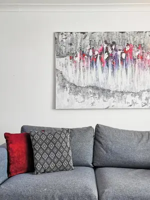a living room with a couch and a painting on the wall at Vkm Apartments in Glasgow