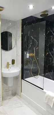a bathroom with a sink and a mirror at Vkm Apartments in Glasgow