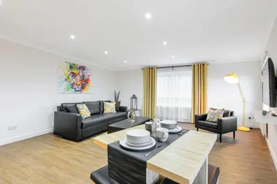 a living room with a couch and a table at Vkm Apartments in Glasgow