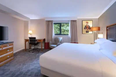 a hotel room with a large bed and a desk at Delta Hotels by Marriott Edinburgh in Edinburgh