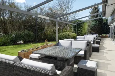 a patio with a table and chairs in a yard at Delta Hotels by Marriott Edinburgh in Edinburgh