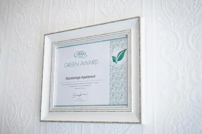 a picture of a framed diploma on a wall at Edinburgh, Stockbridge Apartment in Edinburgh