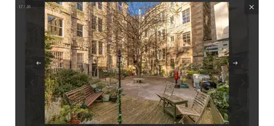 a view of a street with benches and buildings at Edinburgh, Stockbridge Apartment in Edinburgh