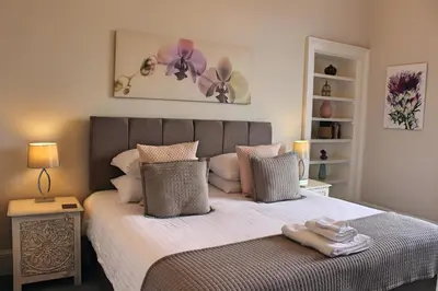 a bedroom with a bed with towels on it at Kirk View Apartment in Stirling