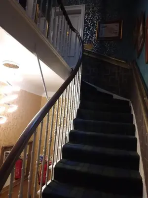 a stairway in a house with a stair case at IVY- Braveheart Guest House in Edinburgh