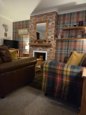 a living room with a couch and a fireplace at Tigh Na Mara in Furnace