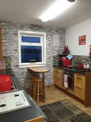 a kitchen with a counter and a window and a table at Tigh Na Mara in Furnace