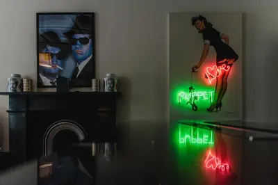 a living room with neon signs on the wall at The Rutland Hotel & Apartments in Edinburgh