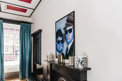 a living room with a large painting on the wall at The Rutland Hotel & Apartments in Edinburgh