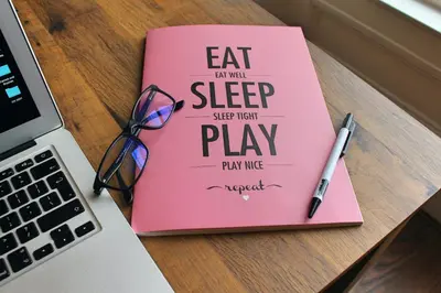 a book sitting on a table next to a laptop at Wallace View Apartment in Stirling