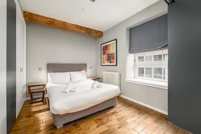 a bedroom with a bed and a window at Destiny Scotland -The Malt House Apartments in Edinburgh