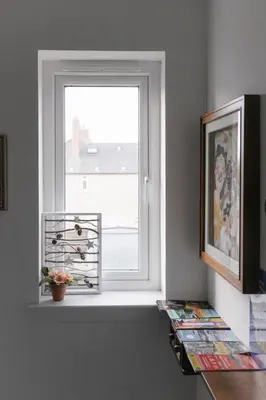 a window with a potted plant sitting on a window sill at BroomHouse HomeStay in Edinburgh
