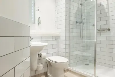 a white bathroom with a toilet and a shower at The Hawes Inn by Innkeeper's Collection in Queensferry