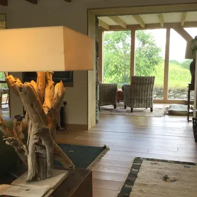 a living room with a table with a tree stump in it at Winterton in Lochgilphead