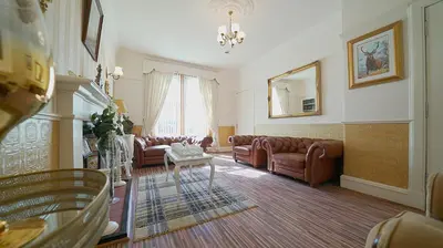 a living room with couches and a table at The Old Tramhouse Self Catering Apartments in Stirling
