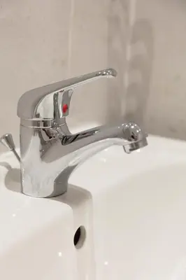 a silver faucet on a white bathroom sink at Ailsa Retreat in Troon