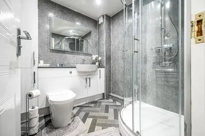 a bathroom with a toilet and a sink and a shower at Super Prime Luxury Waterfront View DBay by TBA in Saint Davids