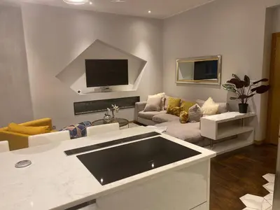 a living room with a couch and a tv at 2 bed Chic Apartment in Glasgow City Centre in Glasgow