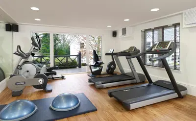 a gym with treadmills and exercise equipment in a room at Wyndham Duchally Country Estate in Auchterarder