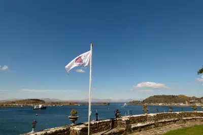 a flag flying in front of a body of water at Dungallan Country House in Oban