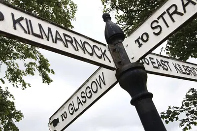 a street sign with two white signs on a pole at Eglinton Arms Hotel, BW Premier Collection in East Kilbride