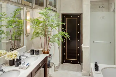a bathroom with two sinks and a black door at 100 Princes Street in Edinburgh