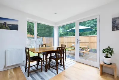 a kitchen and dining room with a table and chairs at Trinity Lodge - Home with Private Garden and Parking in Edinburgh