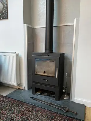 a fireplace with a stove in a room at Trinity Lodge - Home with Private Garden and Parking in Edinburgh