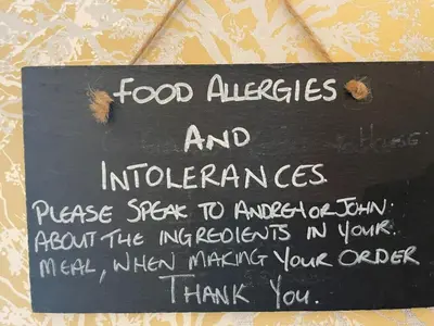 a sign with food allergies and intolerances on it at Gowanlea Guest House in Balloch