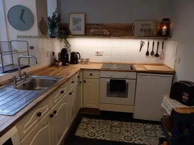 a kitchen with a sink and a stove at Lovely house next to Euchan River in Sanquhar