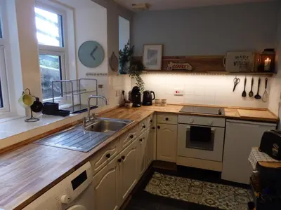 a kitchen with a sink and a counter top at Lovely house next to Euchan River in Sanquhar
