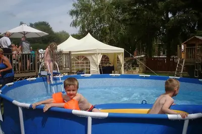 two young boys are in a swimming pool at Three Bridges Bed & Breakfast in Rosyth