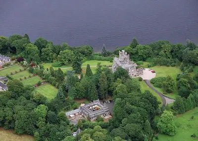 an aerial view of an old castle in the trees at Coachouse in Balloch