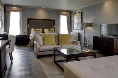 a living room with a couch and a bed at Best Western Garfield House Hotel in Chryston