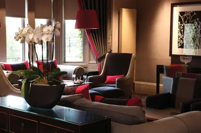 a waiting room with couches and chairs at Best Western Garfield House Hotel in Chryston