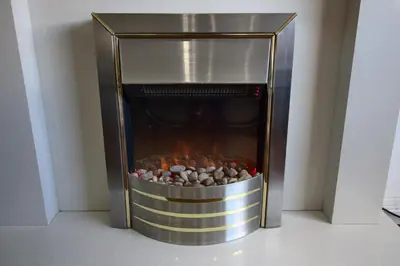 a metal fireplace with a fire inside of it at The Marlfield in Bellshill