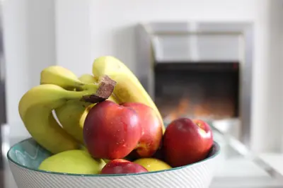 a bowl of fruit with bananas and apples at The Marlfield in Bellshill