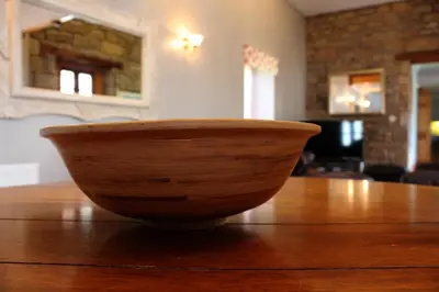 a wooden bowl sitting on top of a wooden table at Smiddy Lodge in Balloch