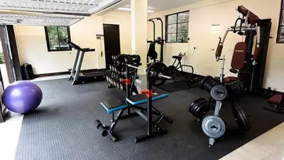 a gym with weights and exercise equipment in a room at Chapelhill in Helensburgh