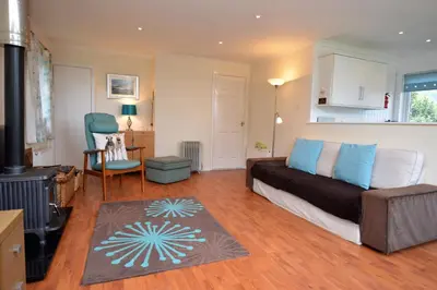 a living room with a couch and a chair at Amber Lodge in Hunters Quay