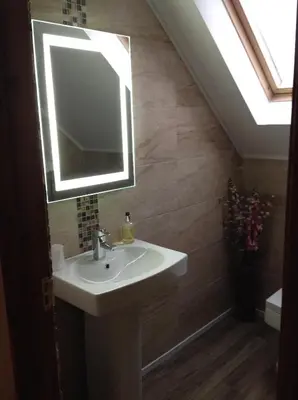 a bathroom with a sink and a mirror at Inverasdale in Oban