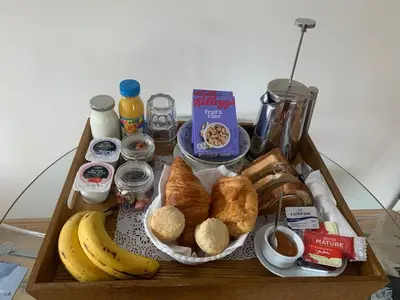 a tray of breakfast food on a table with bananas and bread at Inverasdale in Oban