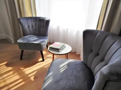 a living room with a couch and a chair and a table at Signature - Langlands House in Glasgow