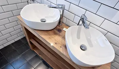 a bathroom with a white sink and a toilet at Lapwing Lodge with loch and mountain view in Crianlarich