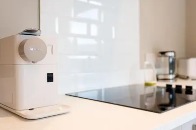 a coffee maker sitting on a counter in a kitchen at Stunning 5 star lodge with loch and mountain views in Crianlarich