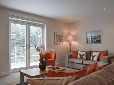 a living room with a couch and a table at Can Duran in Killin