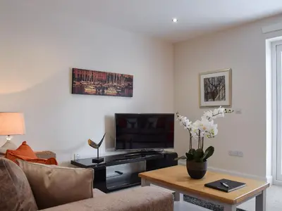 a living room with a couch and a tv at Can Duran in Killin