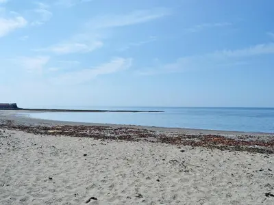 a sandy beach with the ocean in the background at Ingleside in Ballantrae